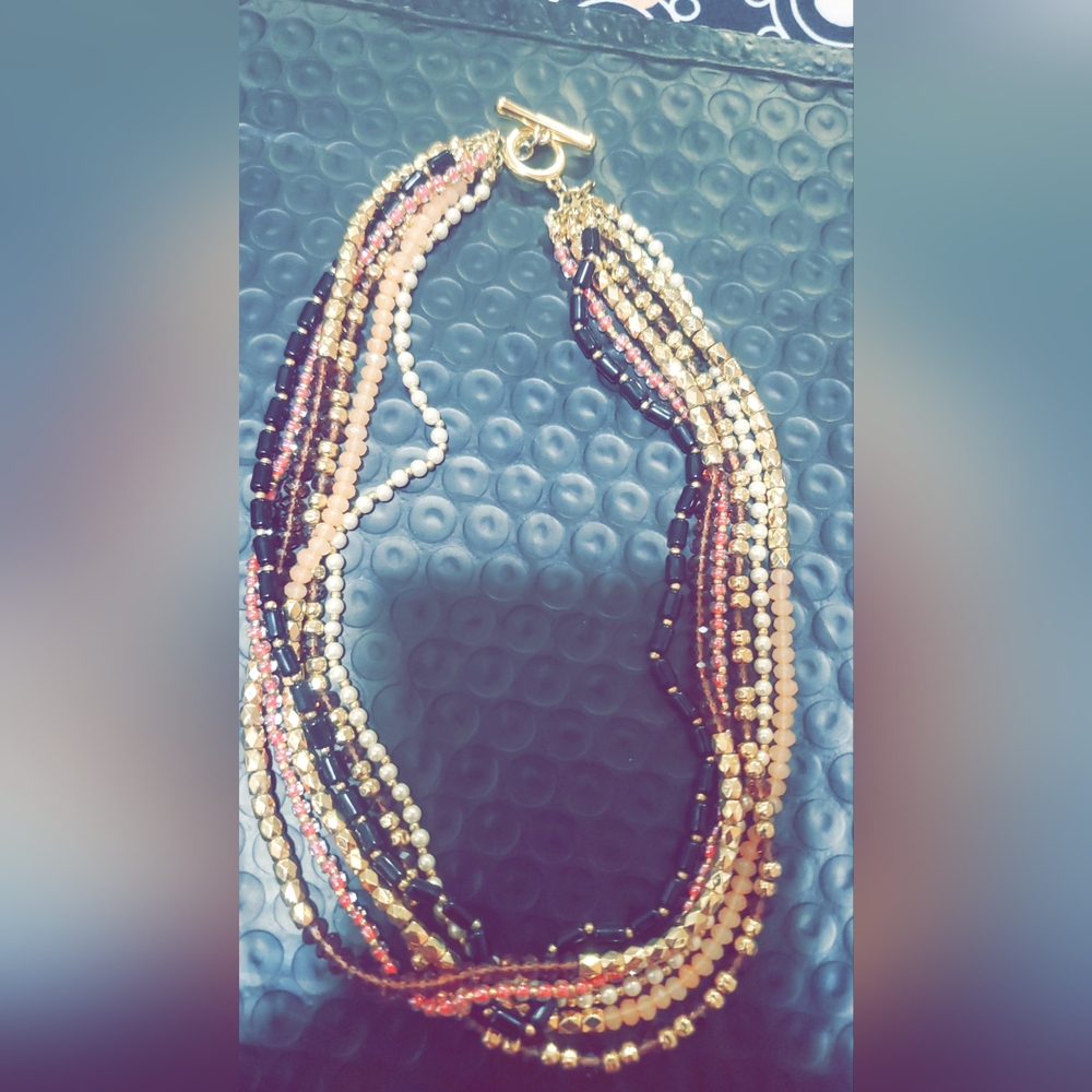 Beaded multiple stranded necklace, gold clasp. Pink, pearl, black and gold beads